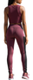 Woman wearing high-rise color block leggings with black slimming panels, maroon accents, and side pockets, standing in a sporty pose.