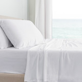 side view of a bed with white classic sheets