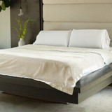 coconut milk fleece blanket on a bed