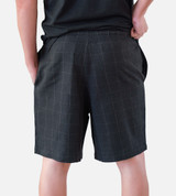 close-up back view of model wearing woven black shorts