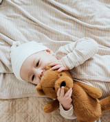 baby laying on stripes receiving blanket