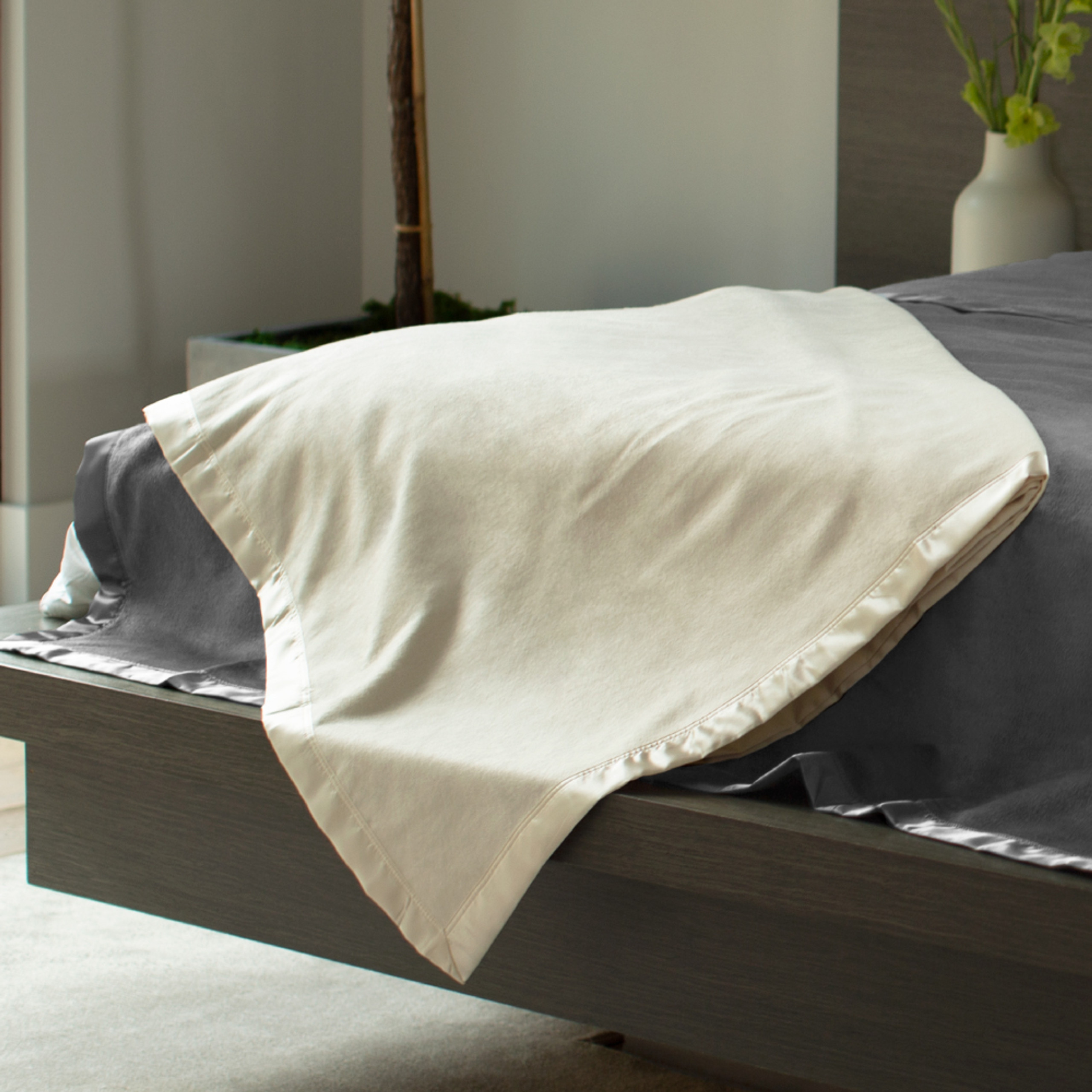 a tan fleece blanket on a bed