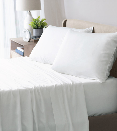 white cooling performance sheets on a bed