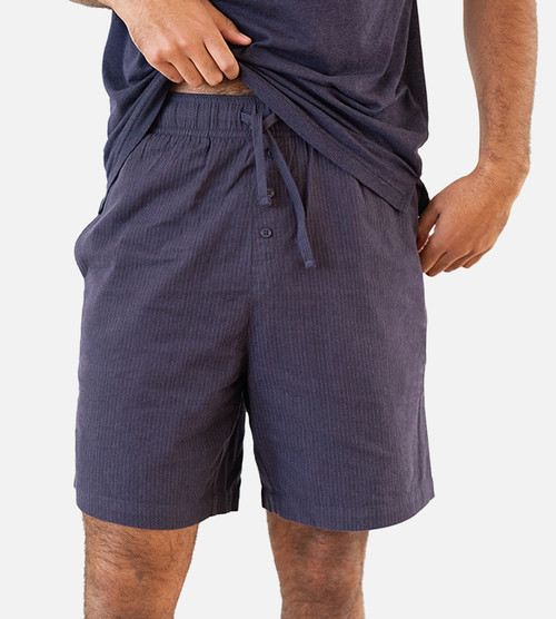 close-up front view of model wearing woven navy shorts