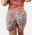 back view of models legs wearing blush foliage print sleep shorts