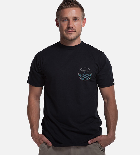 front view of model wearing black crew tee with left chest high tide design