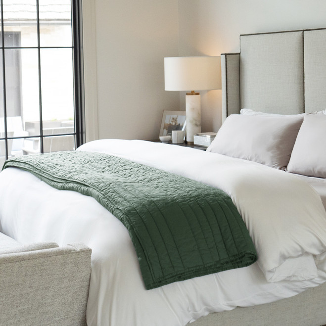oasis green draped on a bed