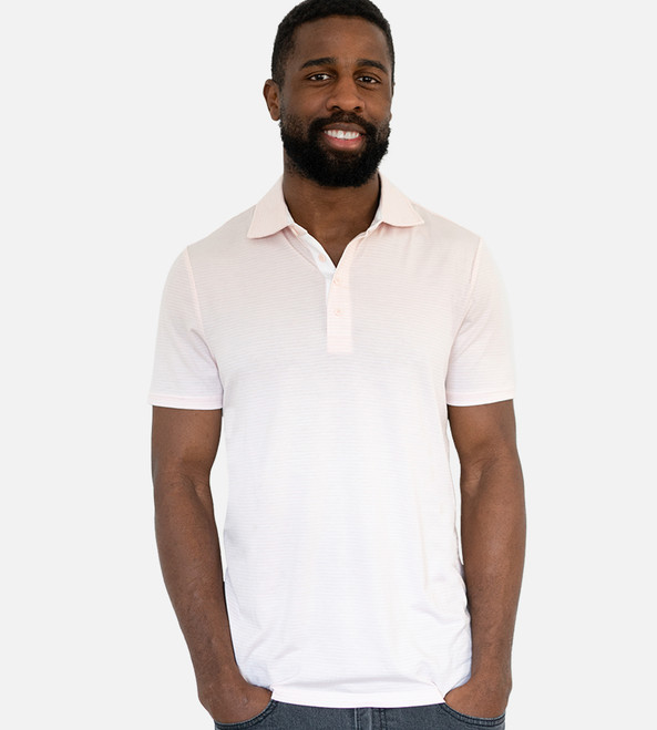 man wearing a light pink striped polo