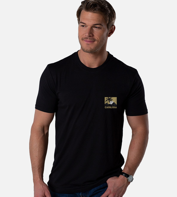 front view of model wearing black crew with left chest lagoon sunset design