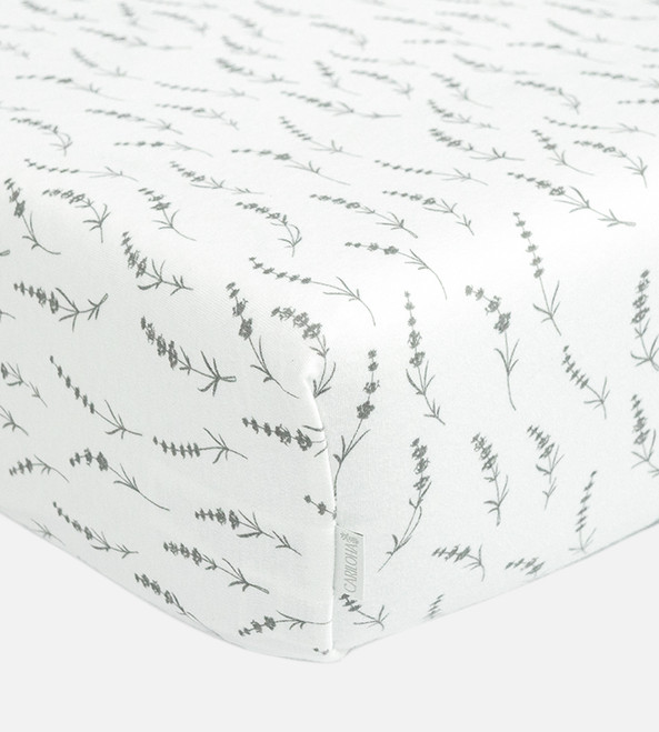 corner of mattress showing wildflowers hush gray sheets on them