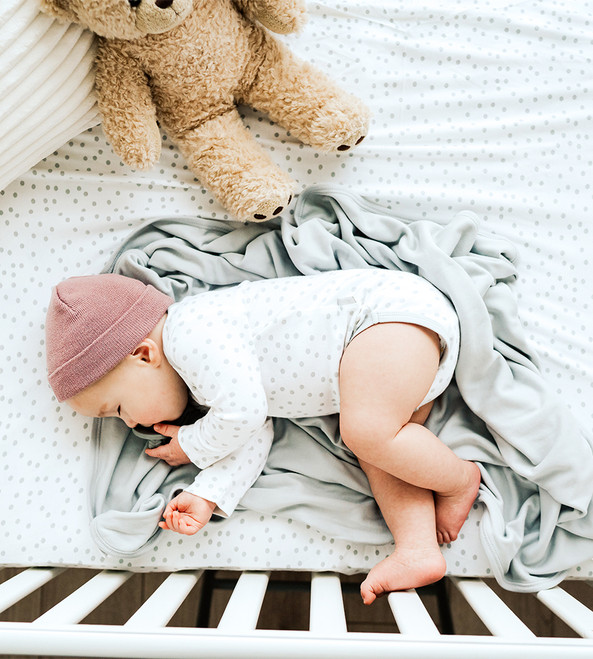 baby wearing dot bodysuit
