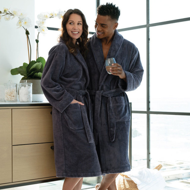 a man and woman wearing Cariloha bathrobes