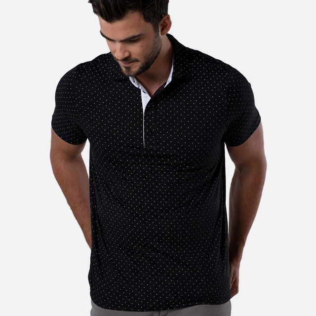 a man wearing a black polo with white dots