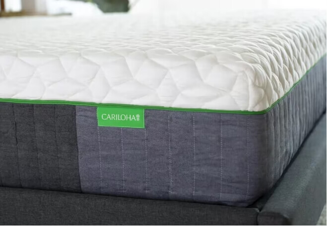 a woman lying on an adjustable base and mattress