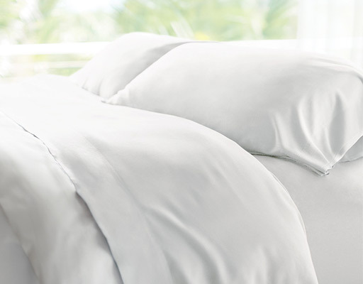 white cooling sheets on bed