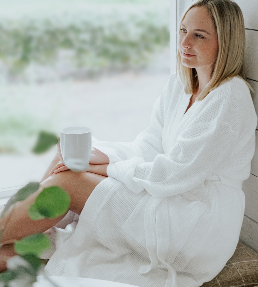 a woman wearing a white waffle knit robe
