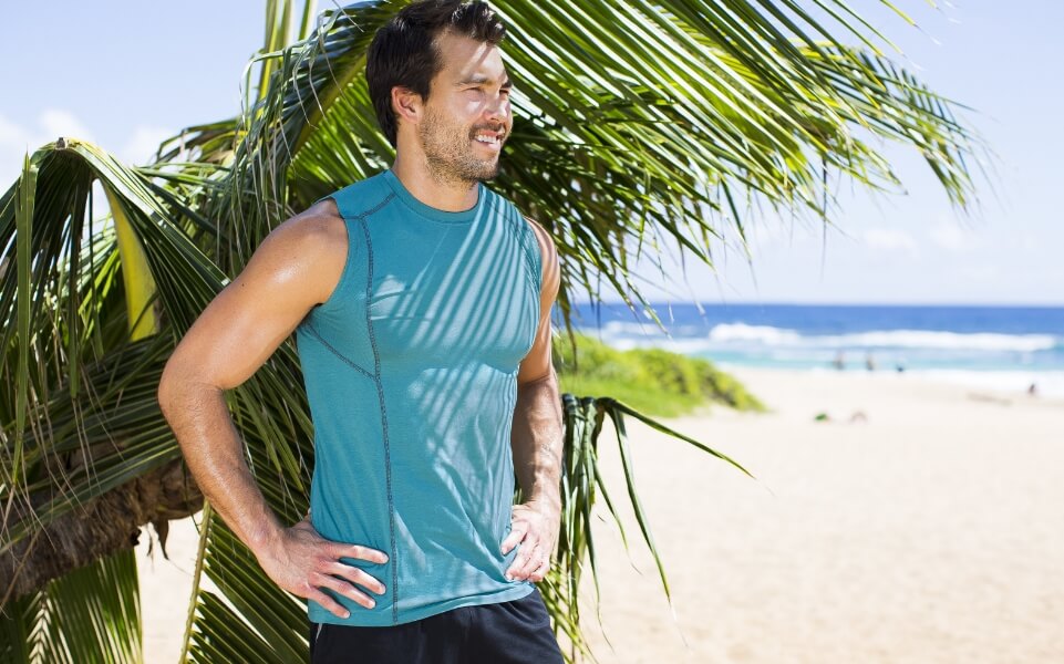 man wearing bamboo fit clothing standing on a beach