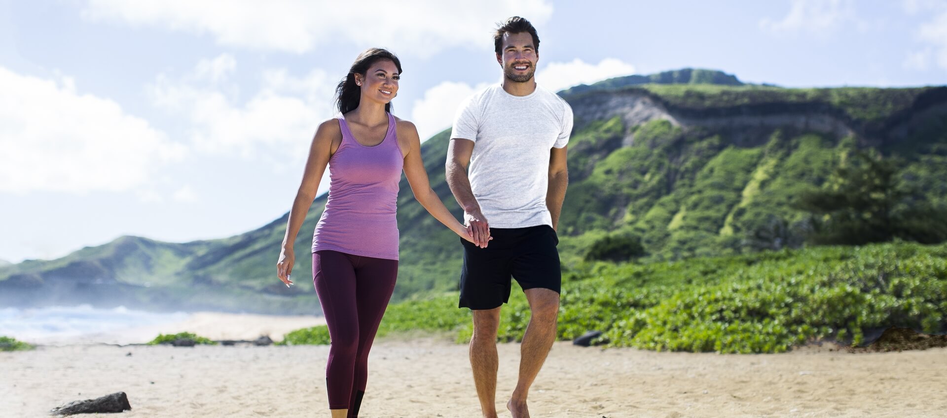 Man and Woman walking on a beach wearing bamboo fit clothing