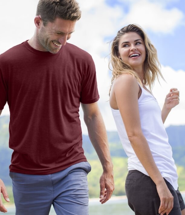 Man and Woman wearing cariloha bamboo shirts on a beach