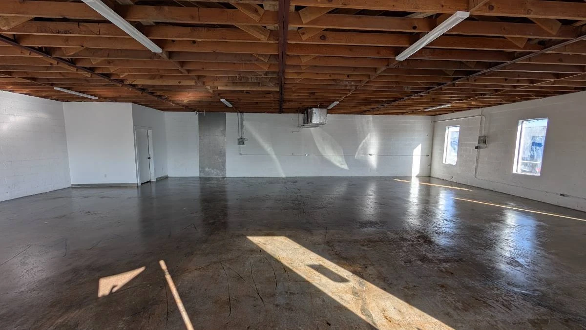 Open studio with wood-beam ceiling