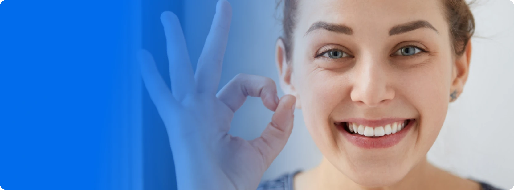 Woman smiling while using teeth whitening products