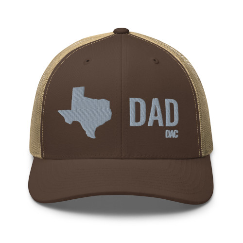 Brown/Khaki six-panel mesh-back trucker cap with embroidered Texas DAD logo, front view — DAD all caps