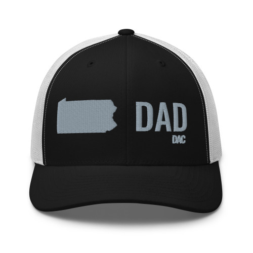Black/White six-panel mesh-back trucker cap with embroidered Pennsylvania DAD logo, front view — DAD all caps