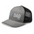 Heather Black six-panel mesh-back trucker cap with embroidered Boy DAD logo, left-front view — DAD all caps