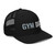 Black six-panel snapback-style trucker cap with embroidered Gym DAD logo, right-front view — DAD all caps