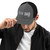 Charcoal/Black six-panel snapback-style trucker cap with embroidered Run DAD logo, front view — DAD all caps