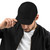 Black six-panel snapback-style trucker cap with embroidered Night Owl DAD logo, front view — DAD all caps