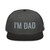 Black/Charcoal Gray structured high-profile six-panel snapback hat with embroidered I'm DAD logo, front view — DAD all caps