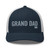 Navy/White six-panel mesh-back trucker cap with embroidered Grand DAD logo, front view — DAD all caps