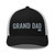 Black/White six-panel mesh-back trucker cap with embroidered Grand DAD logo, front view — DAD all caps