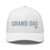 White six-panel mesh-back trucker cap with embroidered Grand DAD logo, front view — DAD all caps