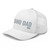 White six-panel mesh-back trucker cap with embroidered Grand DAD logo, left-front view — DAD all caps