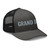 Charcoal/Black six-panel mesh-back trucker cap with embroidered Grand DAD logo, right-front view — DAD all caps