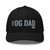 Black six-panel mesh-back trucker cap with embroidered OG DAD logo, front view — DAD all caps