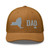 Caramel six-panel mesh-back trucker cap with embroidered New York DAD logo, front view — DAD all caps