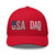 Red six-panel mesh-back trucker cap with embroidered USA DAD logo, front view — DAD all caps
