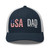 Navy/White six-panel mesh-back trucker cap with embroidered USA DAD logo, front view — DAD all caps