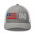 Heather Grey/White six-panel mesh-back trucker cap with embroidered Flag DAD logo, front view — DAD all caps