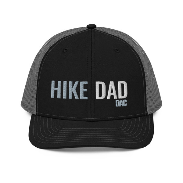 Black/Charcoal six-panel snapback-style trucker cap with embroidered Hike DAD logo, front view — DAD all caps