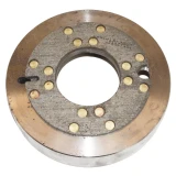 Close-up of a round Allis-Chalmers tractor brake drum with a gray riveted friction lining, large center opening, and a smaller mounting hole on one side.