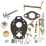 A collection of carburetor parts and gaskets for Allis-Chalmers tractors, including various screws, washers, jets, and gaskets, arranged on a white background.