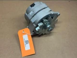 63 Amp One Wire Alternator with Pulley for 6V to 12V Conversion, automotive electrical part displayed on a cardboard surface.