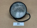 Allis Chalmers Complete Headlight Assembly, 12 Volt B IB C CA, displayed as a used part with a round housing, reflector, and attached wiring, on a plain surface.