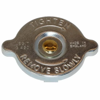 Allis-Chalmers 7 PSI Radiator Cap, vintage metal radiator cap for Allis Chalmers, Case, Ford, IH, John Deere tractors, with embossed lettering and a gold-colored center valve.