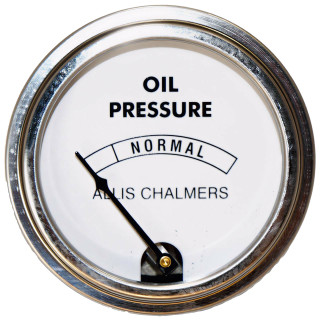 Allis-Chalmers Oil Pressure Gauge, circular engine oil pressure indicator showing normal range and needle pointing to low pressure.