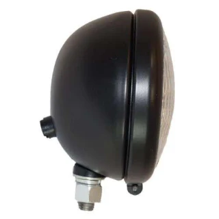 Side view of a black round 12-volt tractor headlight assembly, with a ribbed glass lens, mounting bracket, and threaded connector.